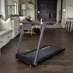 WalkingPad Denise Austin 2.0 foldable treadmill in a home office setting, showing the sleek design and blue color.