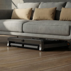 Blue WalkingPad Denise Austin 2.0 foldable treadmill stored under a sofa, showcasing compact design by WalkingPad.