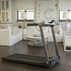 WalkingPad Denise Austin foldable treadmill in a living room setup, showing its sleek design and compact size for home use.