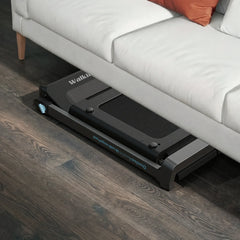 Foldable WalkingPad treadmill by WalkingPad with Denise Austin, stored under a bed in a home setting.