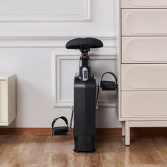 Foldable WalkingPad exercise bike in compact, folded position for easy home storage, designed for under-desk use.