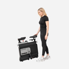 WalkingPad foldable exercise bike with handle, designed for under-desk fitness and convenient storage.