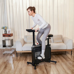 WalkingPad foldable exercise bike in a living room scene, showing a compact under-desk exercise and fitness equipment.