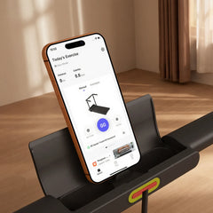 WalkingPad R3 Hybrid+ foldable walking treadmill with phone holder, shown in a home setting with digital display and safety features.