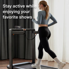 WalkingPad X214 foldable treadmill for walking and running, compact exercise equipment shown on a media stand.