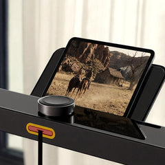 WalkingPad X25 double-folding running treadmill for exercise and fitness, shown in a modern home gym setting.