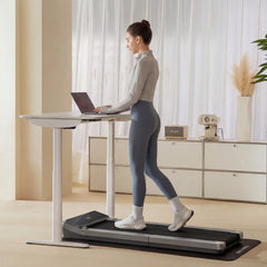 WalkingPad Z3 foldable treadmill placed under a standing desk in a modern home office setting.